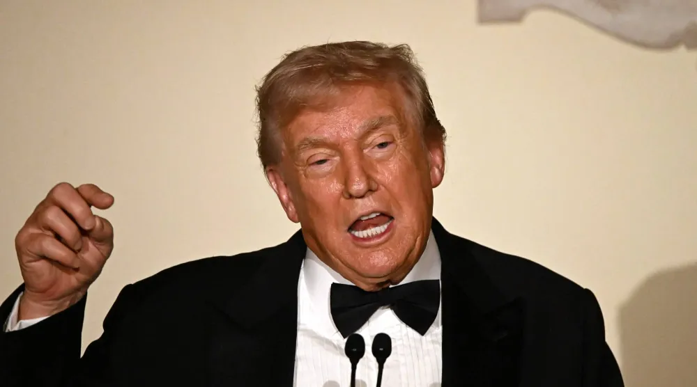 US President Donald Trump delivers remarks during the Congressional Ball in the Grand Foyer of the White House in Washington, DC, on December 11, 2025. (Photo by Alex WROBLEWSKI / AFP)