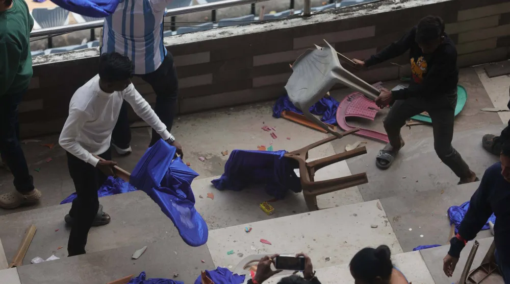 Fans throw bottles and chairs, vandalizing hoardings at Salt Lake Stadium in Kolkata, West Bengal, India, 13 December 2025. Following Messi's brief five-minute appearance, unrest broke out among fans who had paid a significant amount but were unable to see the Argentine football legend.  EPA/PIYAL ADHIKARY