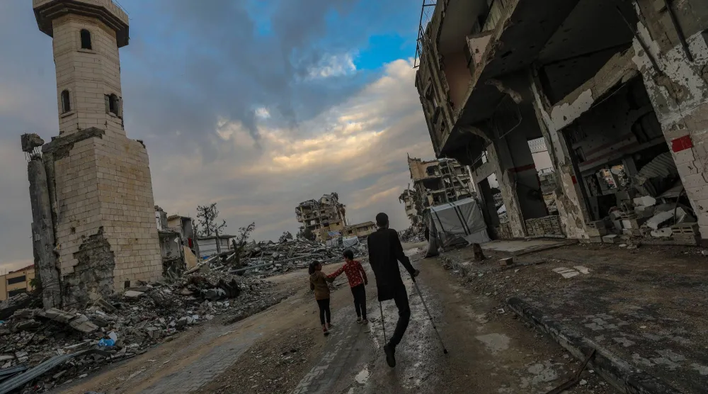 A Palestinian amputee walks in Yafa street among the destroyed Al Mahata mosque and destroyed buildings, in Al Tuffah neighborhood, east of Gaza City, 13 December 2025, near the yellow line amid a ceasefire between Israel and Hamas. EPA/MOHAMMED SABER