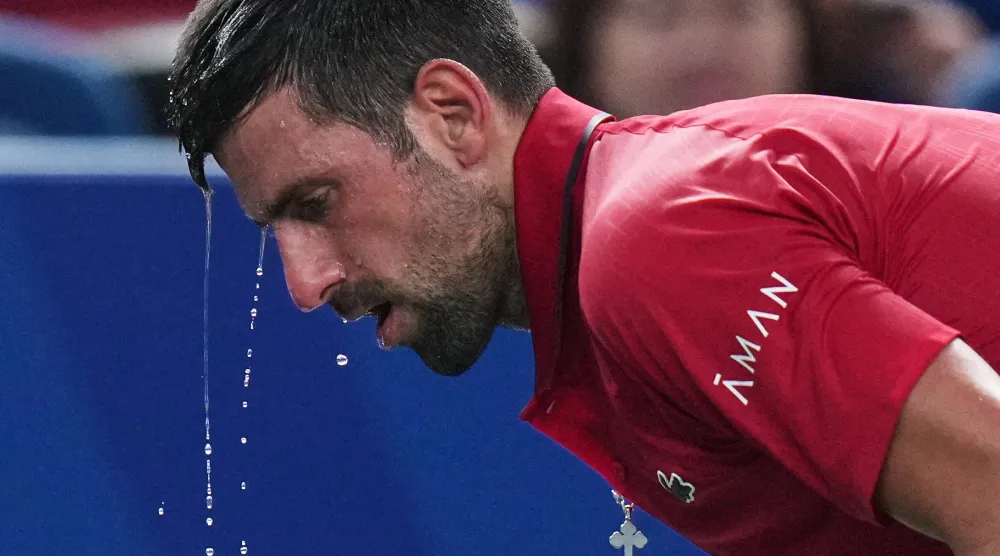 Novak Djokovic of Serbia cools himself with water during the men's singles semifinal match with Valentin Vacherot of Monaco, at the Shanghai Masters tennis tournament at Qizhong Forest Sports City Tennis Center, in Shanghai, China, Saturday, Oct. 11, 2025. (AP)
