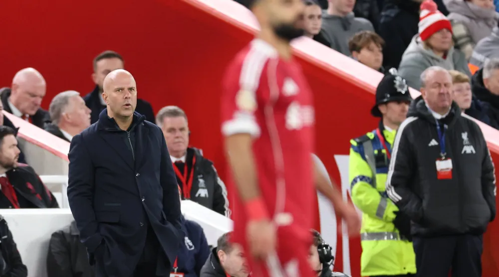 Liverpool manager Arne Slot (L) looks on towards Mohamed Salah of Liverpool (R) during the English Premier League match between Liverpool FC and Brighton & Hove Albion, in Liverpool, Britain, 13 December 2025. EPA/ADAM VAUGHAN 