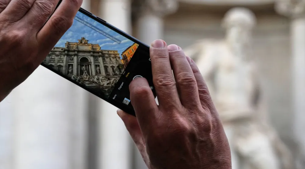  A visitor takes a photo of Rome's Trevi Fountain, Friday, Dec. 19, 2025, as the city municipality announced that, starting on Feb. 1, it will impose a 2 euro fee for tourists to visit the recessed fountain edge. (AP) 