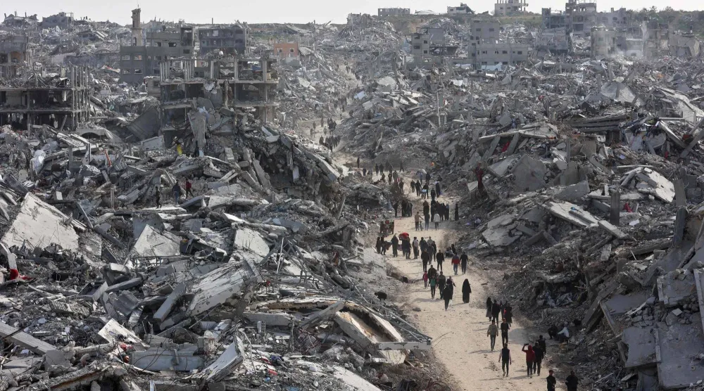 (FILES) This aerial view shows displaced Palestinians returning to the war-devastated Jabalia refugee camp in the northern Gaza Strip on January 19, 2025, shortly before a ceasefire deal in the war between Israel and Hamas was implemented. (Photo by Omar AL-QATTAA / AFP)