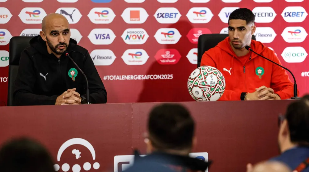 Morocco's head coach Walid Regragui and Morocco's defender #02 Achraf Hakimi attend a press conference at Prince Moulay Abdellah Stadium in Rabat, Morocco on December 20, 2025, ahead of the start of the Africa Cup of Nations (CAN) football tournament. (Photo by Abdel Majid BZIOUAT / AFP)