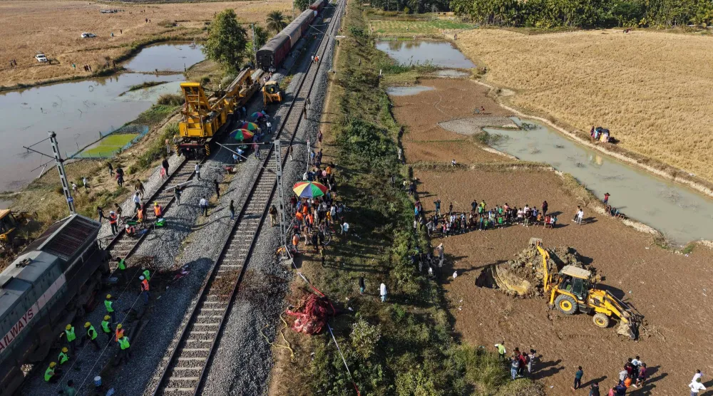 تقوم حفارة بحفر حفرة لدفن جثة فيل بري آسيوي يتم إزالته من على خط سكة حديد بعد أن صدم قطار مسرع قطيعاً من الأفيال البرية (أ.ب)