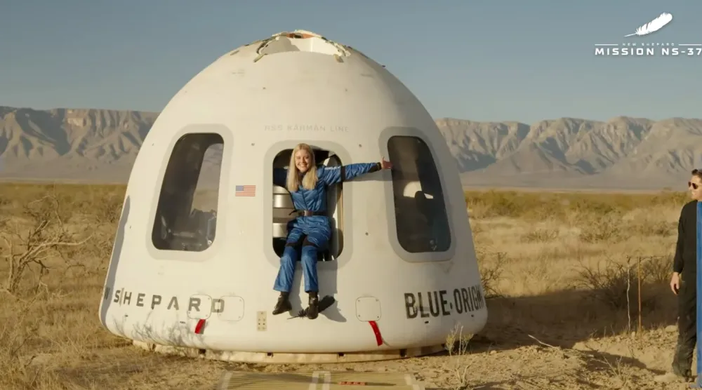 This image provided by Blue Origin, Michaela Benthaus poses after the Blue Origin's capsule landed on Saturday, Dec. 20, 2025 in West Texas. (Blue Origin via AP)
