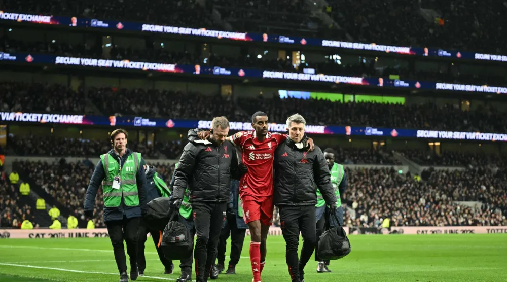 ألكسندر إيزاك يخرج من الملعب بمساعدة الفريق الطبي (أ.ف.ب)