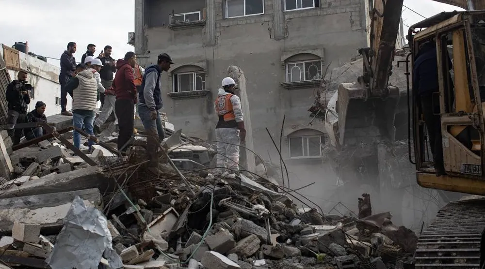 Members of the Palestinian Civil Defense remove the rubble of a destroyed home as they search for the bodies of Palestinians killed during the conflict in Khan Younis, southern Gaza Strip, 20 December 2025. (EPA)