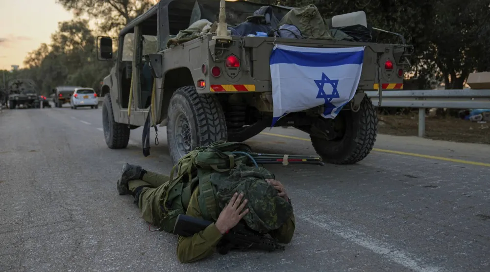جندي إسرائيلي ينبطح أرضاً لدى سماعه دوي صفارات الإنذار بغلاف غزة في أكتوبر 2023 (أ.ب)