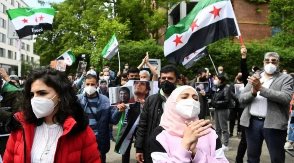 People attend a protest against reelection of Syria's president Bashar al-Assad, near Syria's embassy, Berlin, Germany May 26, 2021. (Reuters)
