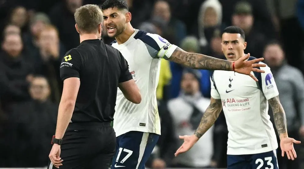 Tottenham Hotspur's Argentinian defender #17 Cristian Romero (C) and Spanish defender #23 Pedro Porro (R) remonstrate with referee John Brooks (L) during the English Premier League football match between Tottenham Hotspur and Liverpool at the Tottenham Hotspur Stadium in London, on December 20, 2025. (AFP)