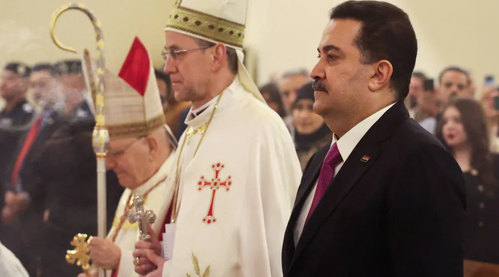 السوداني قال خلال قداس الميلاد إن التطبيع أمر مرفوض في العراق (رويترز)