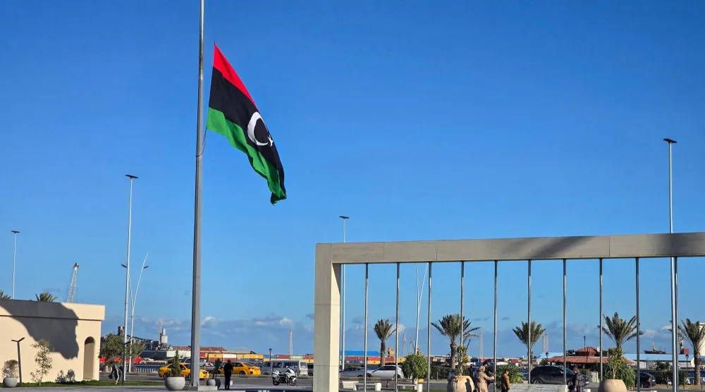 The Libyan national flag flies at half-mast in Tripoli on December 24, 2025, after the head of Libya's armed forces and his four aides died in a plane crash in Türkiye. (AFP)