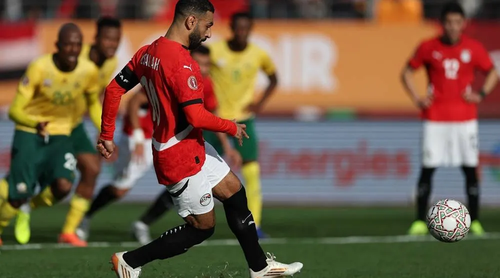  Egypt's forward #10 Mohamed Salah shoots from the penalty spot to score the team's first goal during the Africa Cup of Nations (CAN) Group B football match between Egypt and South Africa at Adrar Stadium in Agadir on December 26, 2025. (AFP) 