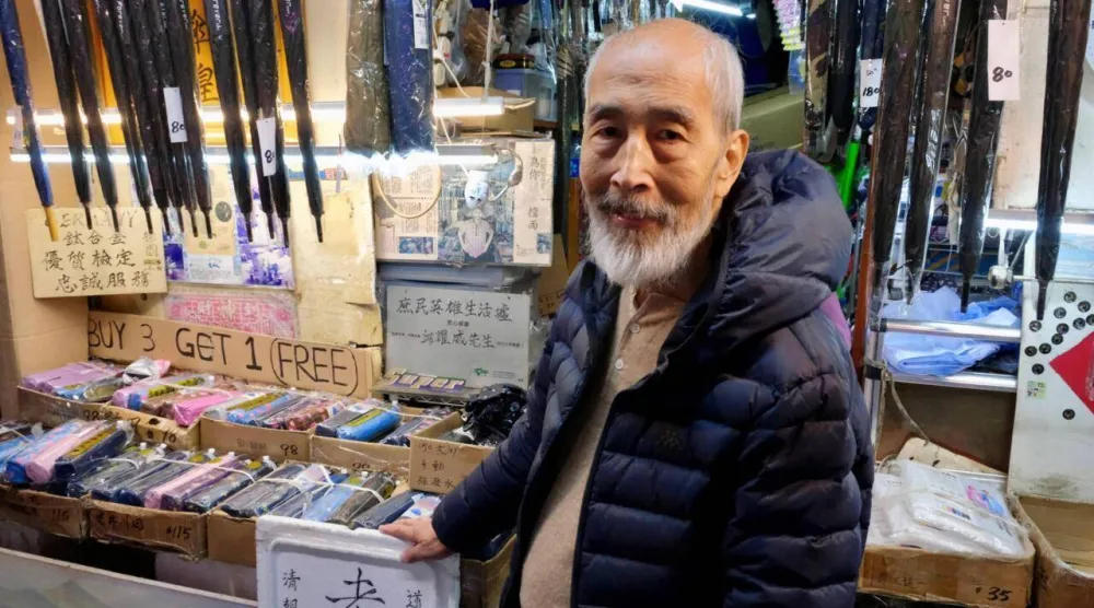 Yau Yiu-wai, 73, one of the few remaining umbrella repairmen in Hong Kong, is closing his 183-year-old family-run business at the end of the year. Tommy WANG / AFP
