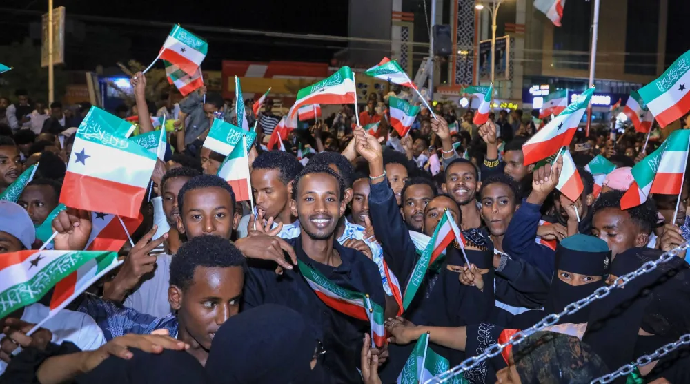 Residents wave Somaliland flags as they gather to celebrate Israel's announcement recognizing Somaliland's statehood in downtown Hargeisa, on December 26, 2025. (AFP)