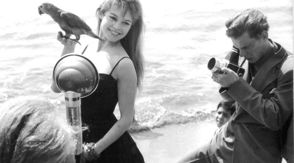 FILED - 01 April 1956, France, Cannes: Then French actress and singer Brigitte Bardot is photographed with a parrot in her hand on the beach during the Cannes Film Festival. Photo: -/AFP Intercontinentale/dpa