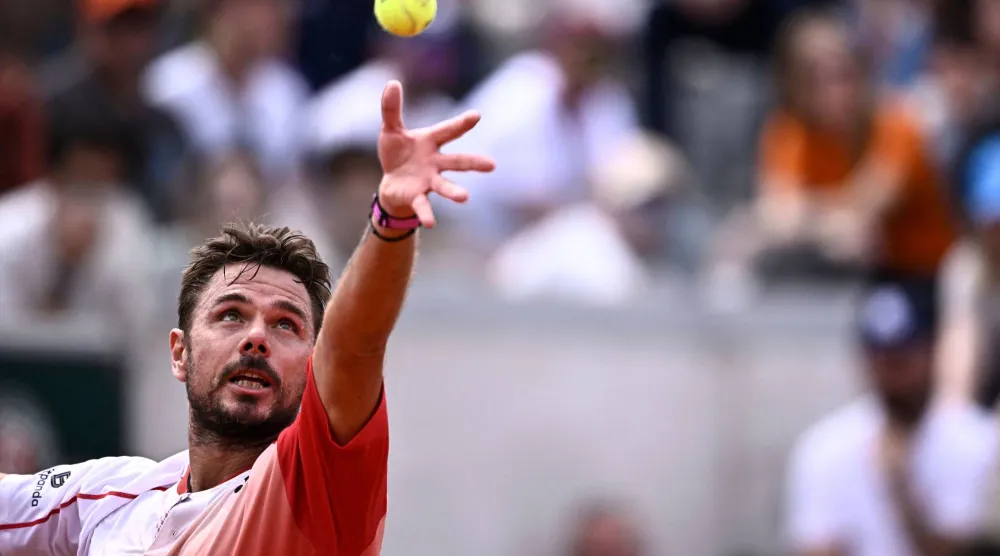 Switzerland's Stan Wawrinka serves to Great Britain's Jacob Fearnley during their men's singles match on day 2 of the French Open tennis tournament at the Roland-Garros Complex in Paris on May 26, 2025. (AFP)
