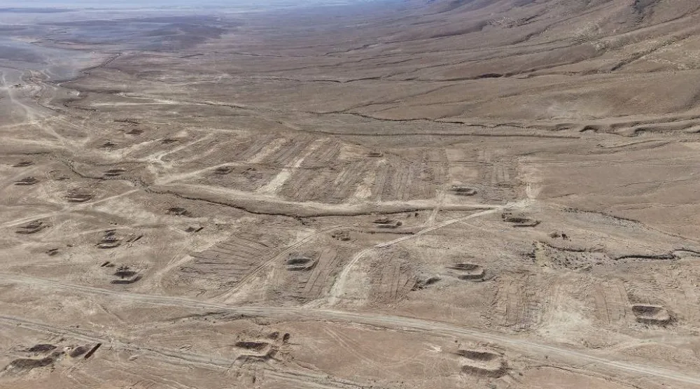 A drone view of the mass grave site in the desert near the eastern Syrian town of Dhumair, February 27, 2025. (Reuters)