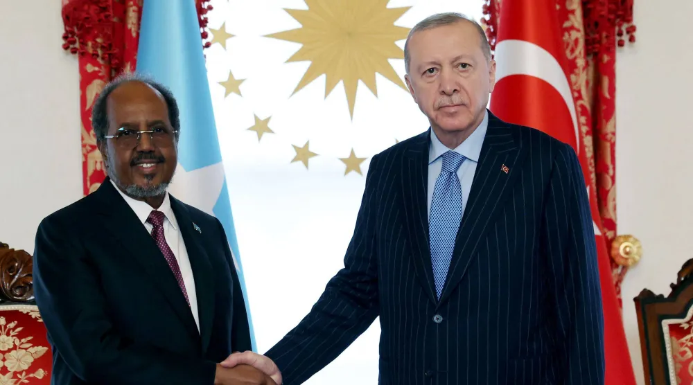 This handout photograph taken and released by the Turkish presidential press service on December 30, 2025, shows Türkiye’s President Recep Tayyip Erdogan (R) and Somalia's President Hassan Sheikh Mohamud (L) shaking hands before their meeting in Istanbul. (Photo by Handout / Turkish Presidential Press Service / AFP) 