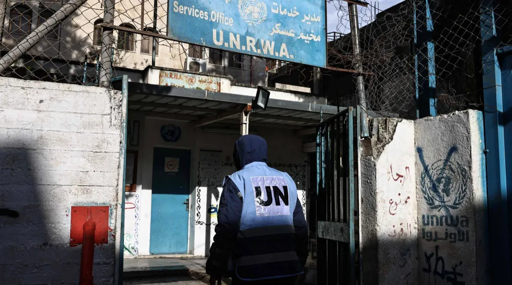 شخص يدخل منشأة تتبع وكالة «الأونروا» في مخيم عسكر بنابلس بالضفة الغربية (أ.ف.ب)