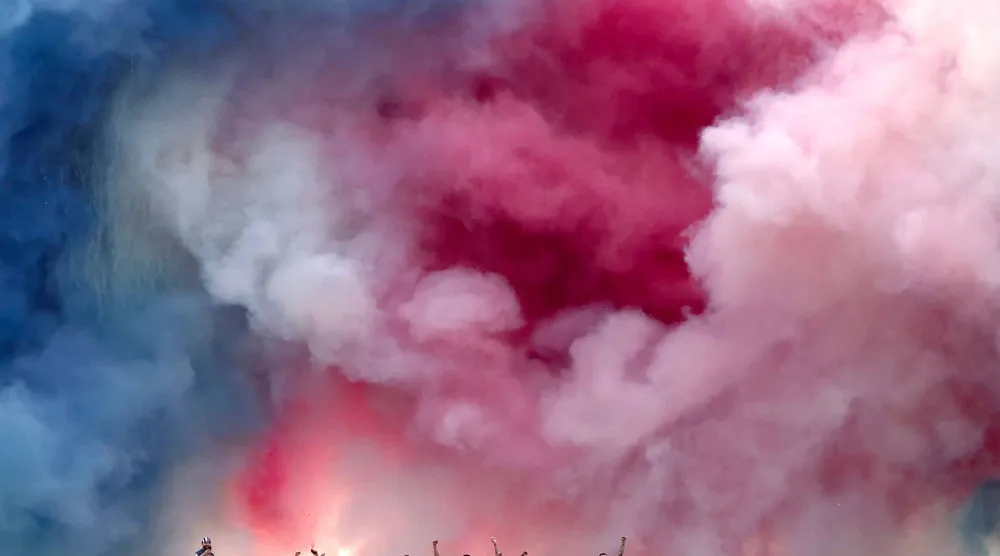 Fireworks explode as Paris Saint-Germain's players parade on a bus on the Champs-Elysees avenue in Paris on June 1, 2025, a day after PSG won the 2025 UEFA Champions League final football match against Inter Milan in Munich. (AFP)
