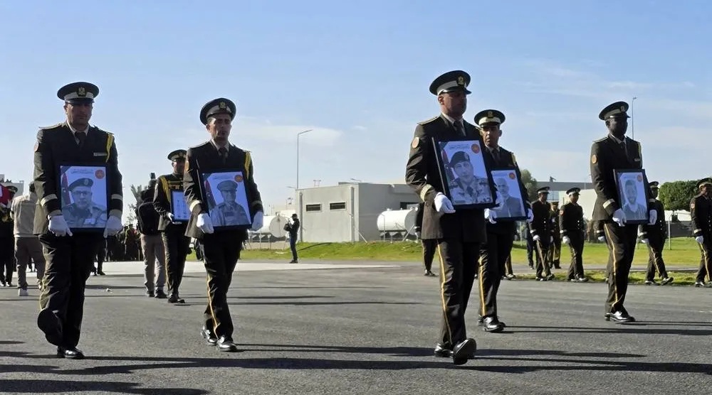 Military personnel carry portraits of the Libyan chief of staff, General Mohamed al-Haddad (2-R), and his four advisers, who were killed in a plane crash in Türkiye, during an official repatriation ceremony at the Ministry of Defense headquarters in Tripoli, Libya, 27 December 2025. (EPA) 