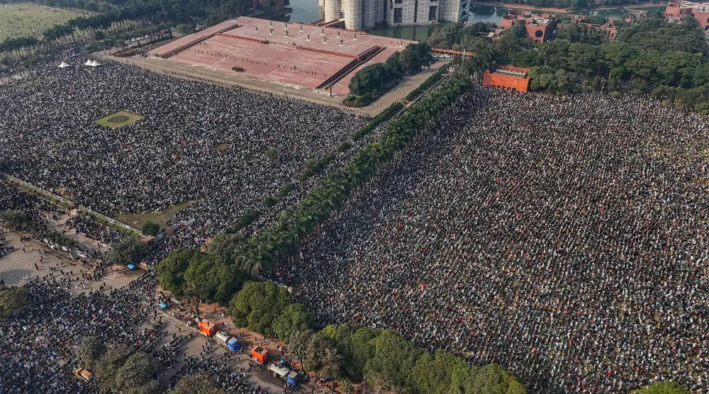 An aerial view shows mourners gathered for the funeral ceremony of Bangladesh's former Prime Minister Khaleda Zia at the Parliament House premises in Dhaka on December 31, 2025 a day after her death. (AFP)