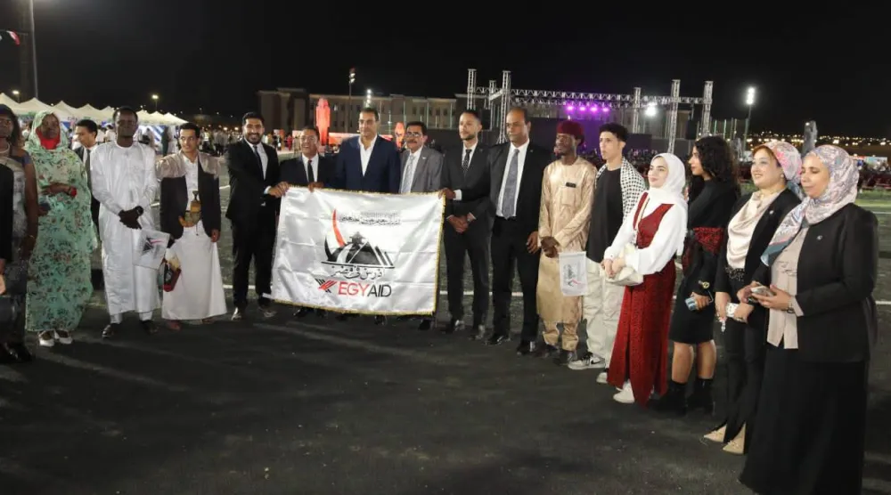 وافدون يحملون لافتة مكتوباً عليها منصة «ادرس في مصر» (مجلس الوزراء المصري)