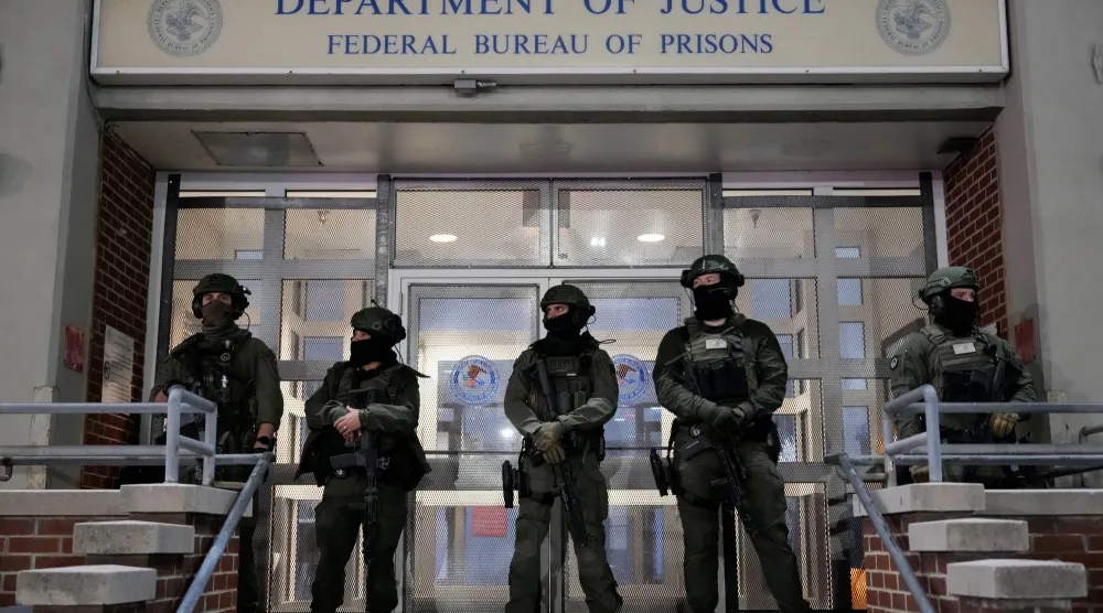  Federal law enforcement personnel stand watch outside the Metropolitan Detention Center as they await the arrival of captured Venezuelan President Nicolas Maduro, Saturday, Jan. 3, 2026, in New York. (AP Photo/Yuki Iwamura) 