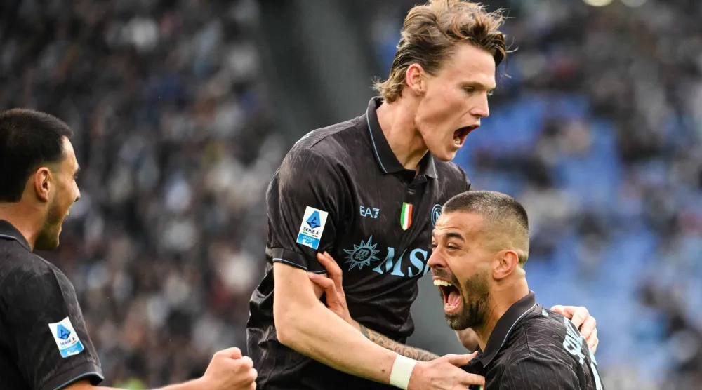  Napoli's Italian defender #37 Leonardo Spinazzola (R) celebrates with Napoli's Scottish midfielder #08 Scott McTominay (C) after scoring his team first goal during the Italian Serie A football match between Lazio and Napoli at the Olympic Stadium in Rome on January 4, 2026. (AFP) 