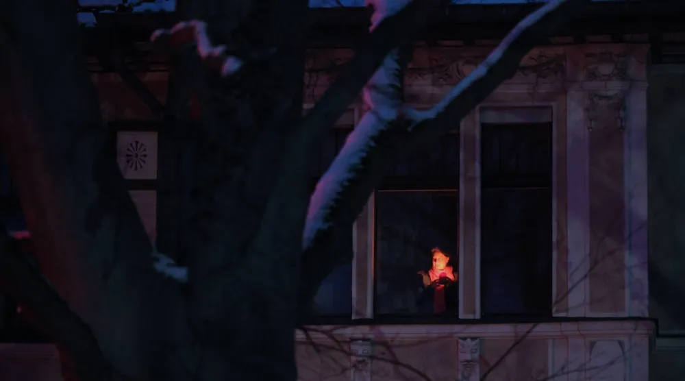 A person with a candle stands at the window during a power outage in southwest Berlin, Germany, 05 January 2026. (EPA)
