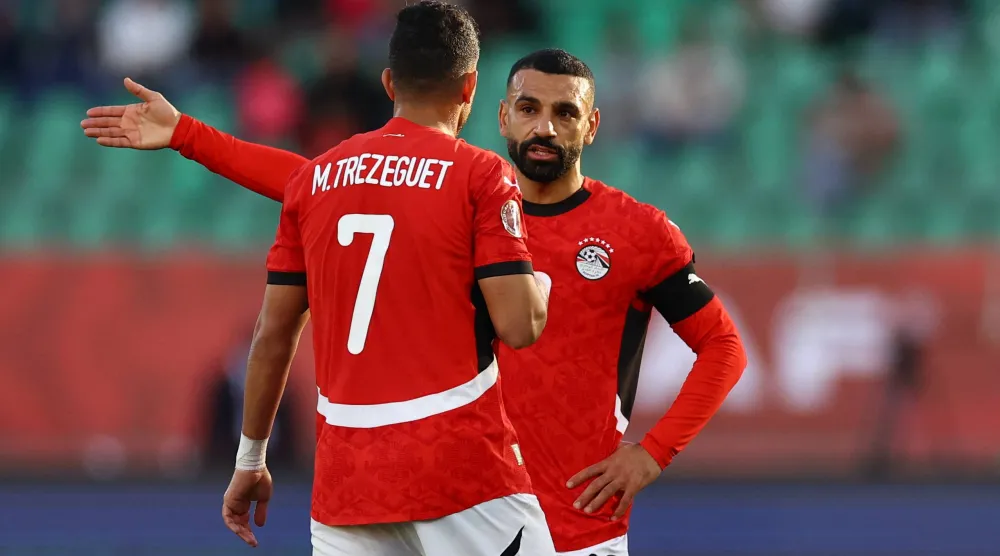 تريزيغيه يتحدث مع صلاح خلال مباراة بنين (رويترز)