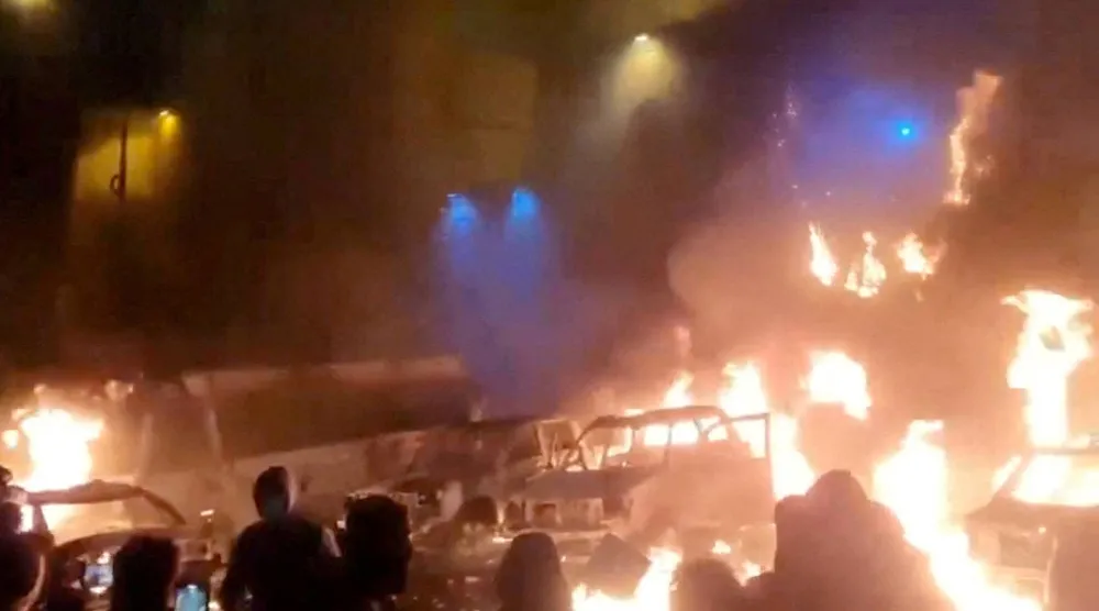 FILE PHOTO: Protesters gather as vehicles burn, amid evolving anti-government unrest, in Tehran, Iran, in this screen grab obtained from a social media video released on January 9, 2026. Social Media/via REUTERS/File Photo