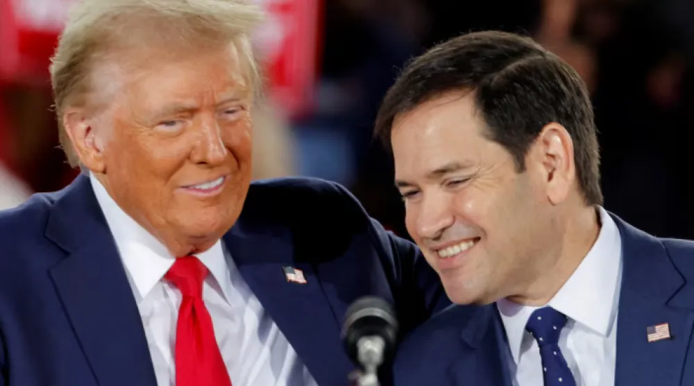 Republican presidential nominee and former US President Donald Trump and Senator Marco Rubio (R-FL) react during campaign event at Dorton Arena, in Raleigh, North Carolina, US November 4, 2024. REUTERS/Jonathan Drake/