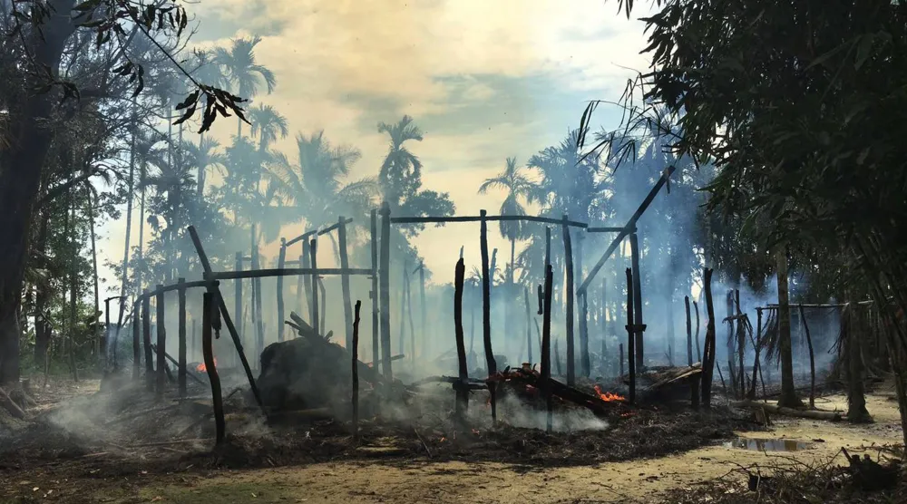 يتصاعد الدخان من منزل محترق في قرية غودو زارا شمال ولاية راخين حيث كانت تعيش الغالبية العظمى من الروهينغا البالغ عددهم 1.1 مليون نسمة في ميانمار (أرشيفية - أ.ب)