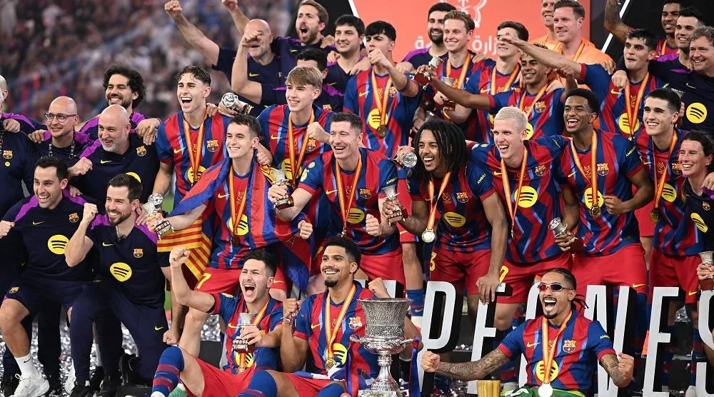 Players of Barcelona celebrate with the trophy after winning the Spanish Super Cup final soccer match between Barcelona and Real Madrid in Jeddah, Saudi Arabia, 11 January 2026. (EPA)