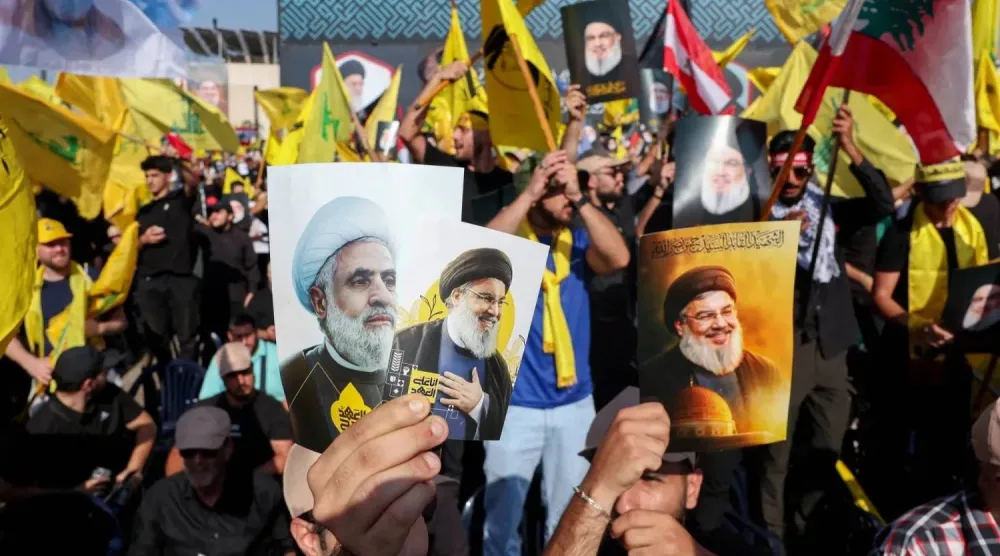 Supporters of Hezbollah hold portraits of its general secretaries on the first anniversary of the assassination of Hassan Nasrallah. (Reuters file)