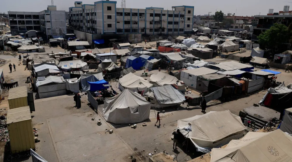 Palestinians displaced by the Israeli military offensive shelter in an UNRWA school, in Khan Younis, in the southern Gaza Strip, August 19, 2025. (Reuters)
