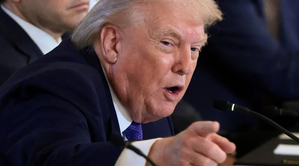 FILE PHOTO: US President Donald Trump points as he attends a meeting with oil industry executives, at the White House in Washington, D.C., US, January 9, 2026. REUTERS/Evelyn Hockstein/File Photo