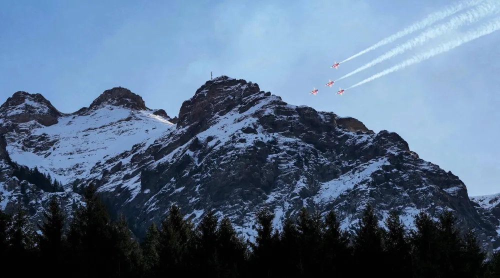 Swiss Air Force's aerobatic team "The Patrouille Suisse" perform prior to the FIS alpine skiing Men's World Cup Super G event in Wengen, Swiss Alps, on January 19, 2026. (Photo by Dimitar DILKOFF / AFP)