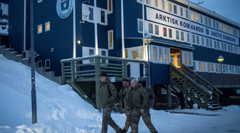 جنود دنماركيون يسيرون أمام مقر «القيادة المشتركة للقطب الشمالي» في نوك بغرينلاند (رويترز)