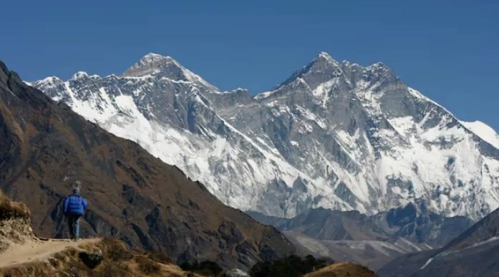 A tourist looks at a view of Mt. Everest from the hills of Syangboche in Nepal December 3, 2009. REUTERS/Gopal Chitrakar
