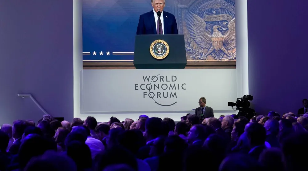 الحضور يستمعون إلى خطاب افتراضي ألقاه ترمب في اجتماع دافوس العام الماضي (أ.ب)