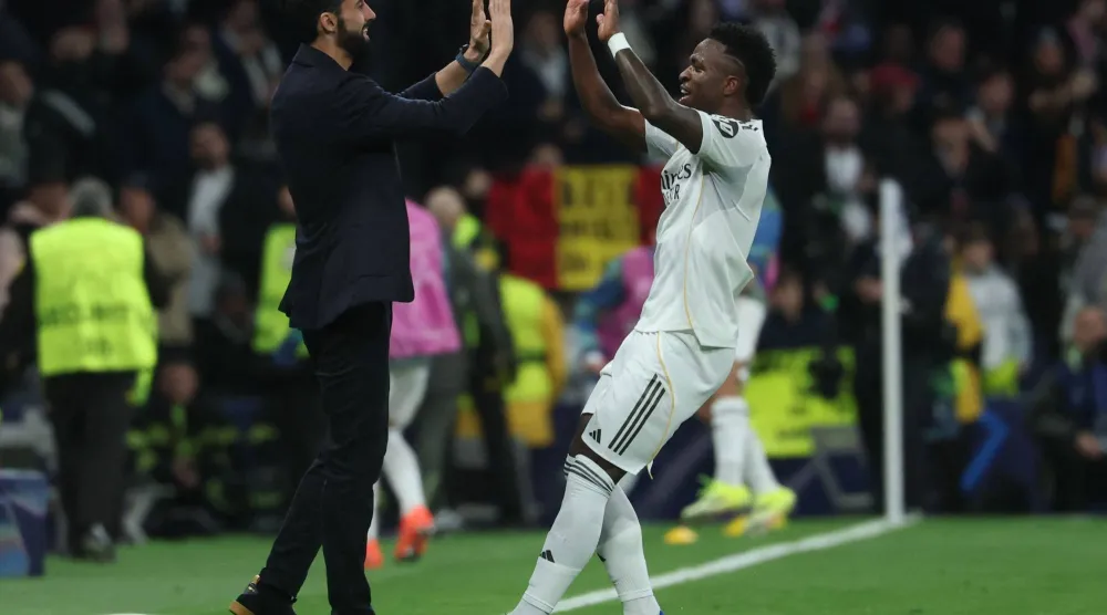 Real Madrid's Brazilian forward #07 Vinicius Junior (R) celebrates scoring his team's fifth goal with Real Madrid's Spanish coach Alvaro Arbeloa during the UEFA Champions League league phase day 7 football match between Real Madrid CF and AS Monaco at Santiago Bernabeu Stadium in Madrid on January 20, 2026. (AFP)