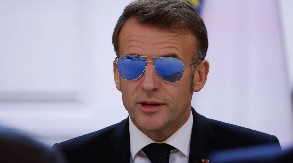  French President Emmanuel Macron, wearing sunglasses, speaks during a meeting on the institutional future of New Caledonia at the Elysee Palace in Paris, France, January 16, 2026. (Reuters)