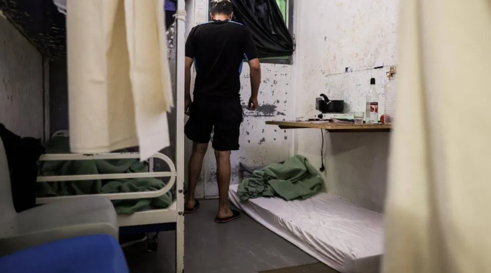 An inmate stands in his two-person cell near a mattress set for a third inmate at Gradignan prison, near Bordeaux, southwestern France, on October 3, 2022. Thibaud Moritz, AFP

