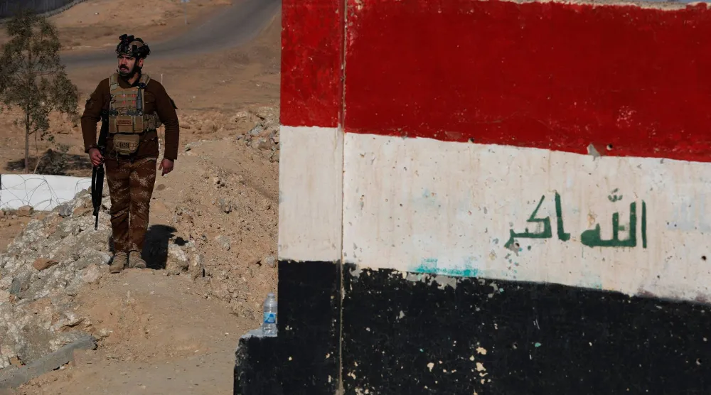 أحد أفراد قوات حرس الحدود العراقية يقوم بدورية على طول جدار خرساني على الحدود العراقية السورية 21 يناير 2026 (أ.ف.ب)