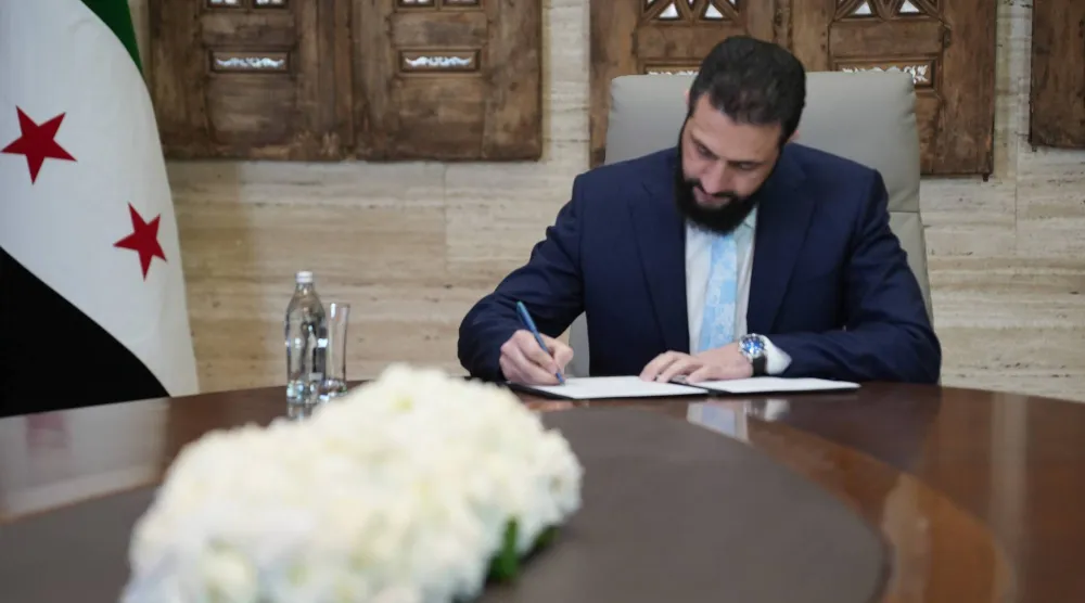 الشرع خلال توقيع اتفاق وقف إطلاق النار مع «قسد» مساء الأحد (إ.ب.أ)