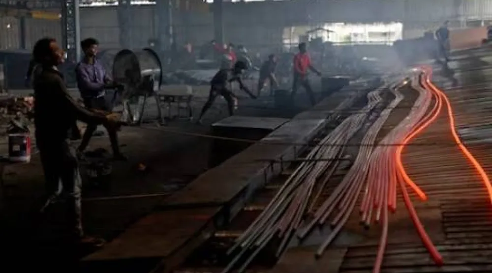 عاملون على خط إنتاج لمعالجة الصلب بمصنع في مدينة ماندي جوبيندغاره بولاية البنجاب الشمالية الهندية (رويترز)